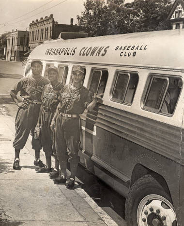 Indianapolis Clown players stand by the team bus. They are Manuel Godines, Reinaldo Verde and Andres Mesa. 1947. Photo courtesy of the Indiana Historical Society.