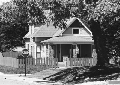 black and white photo of home on corner lot